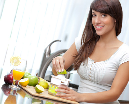 Lady making orange juice
